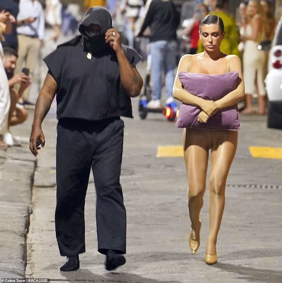 KANYE WEST WIFE BIANCA CENSORI STEPS OUT IN ITALY TOPLESS IN A RIPPED GARMENT WHILE USING A CUSHION TO COVER HER&nbsp;BREAST.